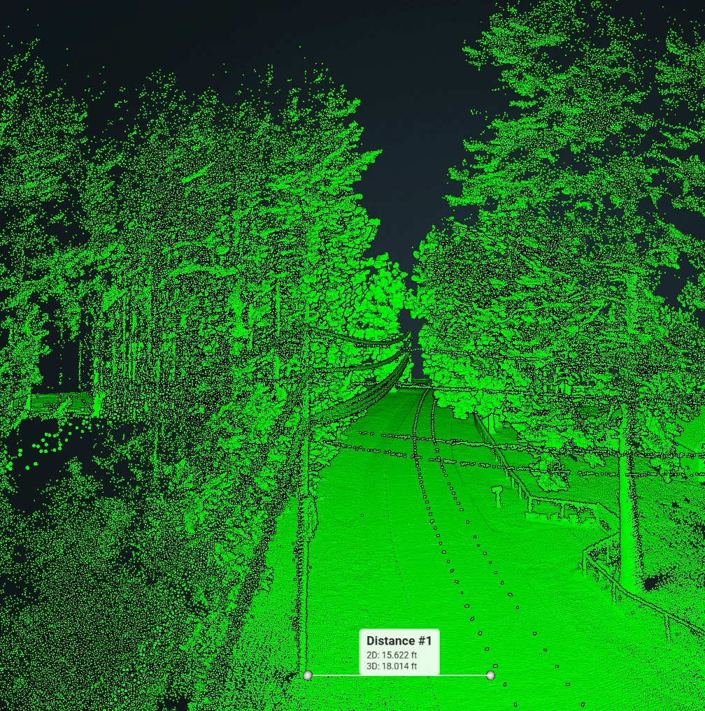 Bright green mobile LiDAR roadway point cloud showing a measured corridor distance